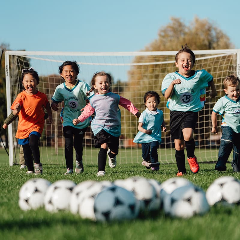 pedlaheads soccer kids running towards the balls at camp