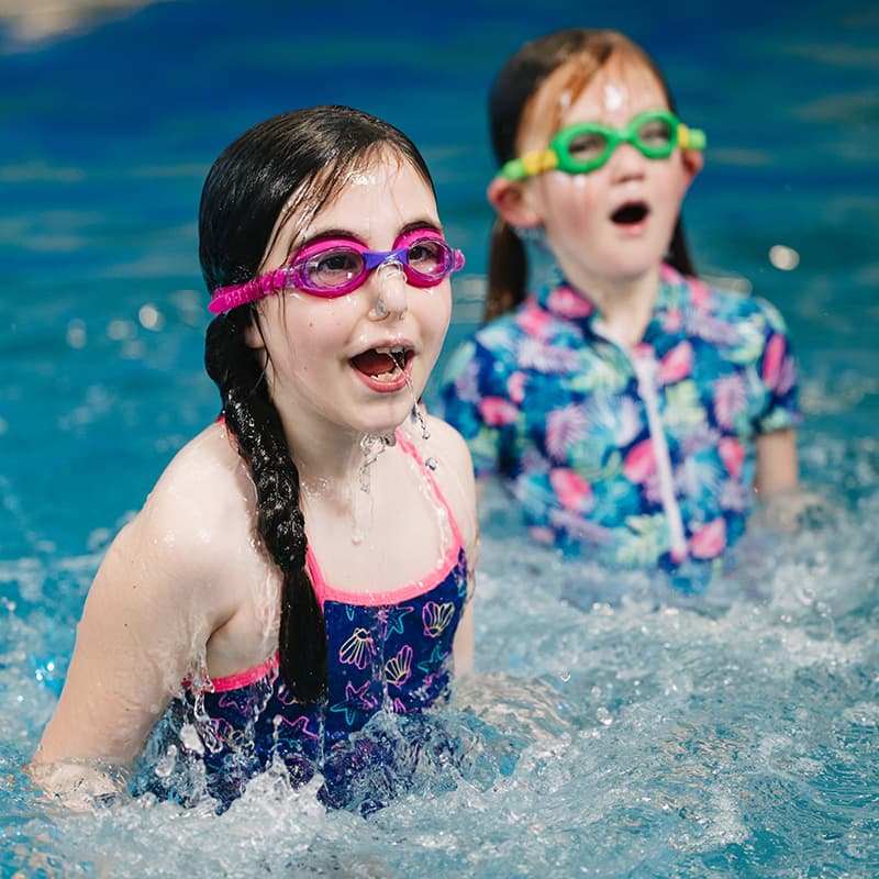 slider 2 girls in swimming lessons in west vancouver