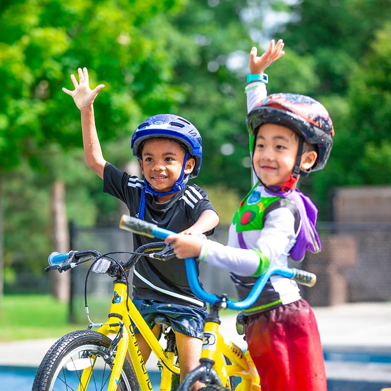 slider 3 two boys learning how to ride in bike lessons