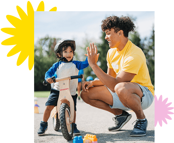 instructor with kid on bike at bike camp