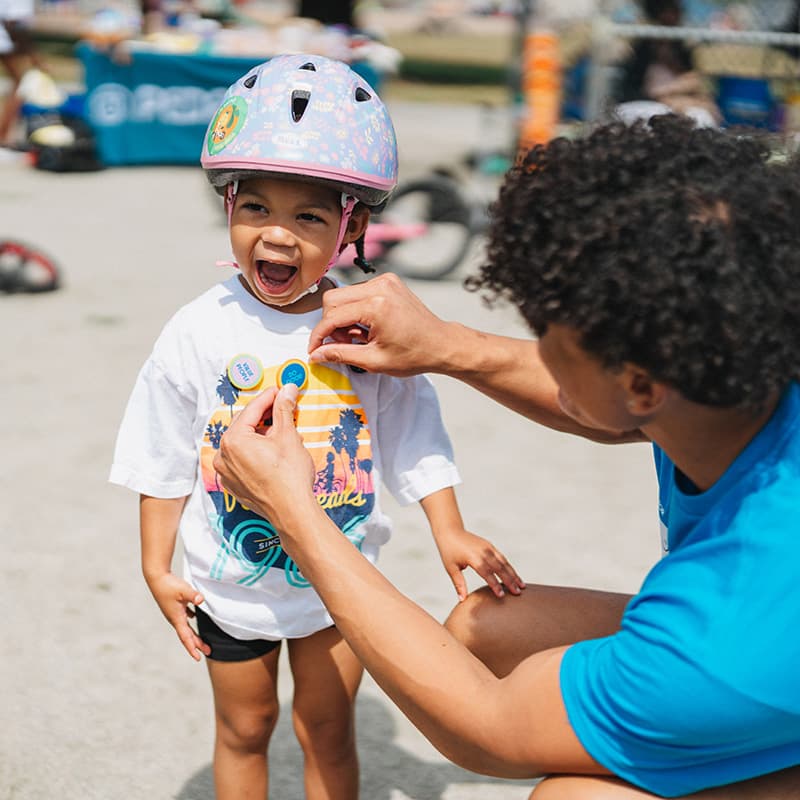 kid receiving do good pin at pedalheads+ camp