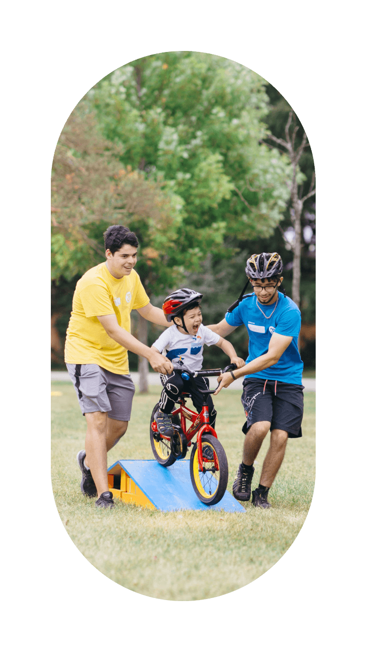 Kid with instructors at Pedalheads bike camp